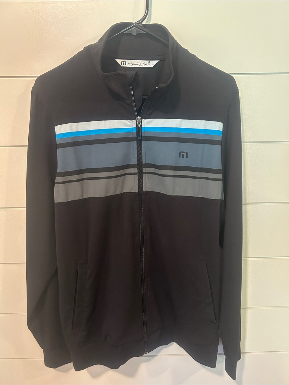 Travis Mathew Black Jacket with Blue and Gray Stripes